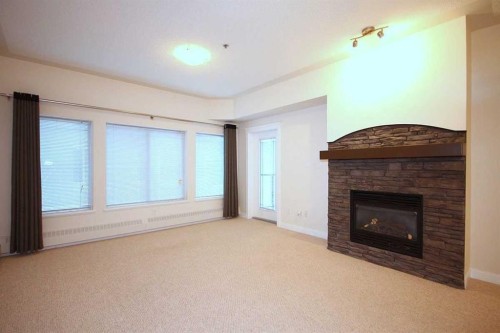518-30 Discovery Ridge Close Sw, Calgary, AB - Indoor Photo Showing Living Room With Fireplace