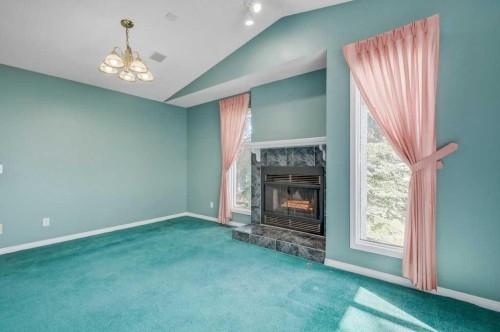 54-5790 Patina Drive Sw, Calgary, AB - Indoor Photo Showing Other Room With Fireplace