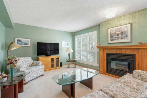 79 Scenic Gardens Nw, Calgary, AB - Indoor Photo Showing Living Room With Fireplace