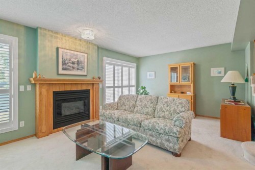 79 Scenic Gardens Nw, Calgary, AB - Indoor Photo Showing Living Room With Fireplace