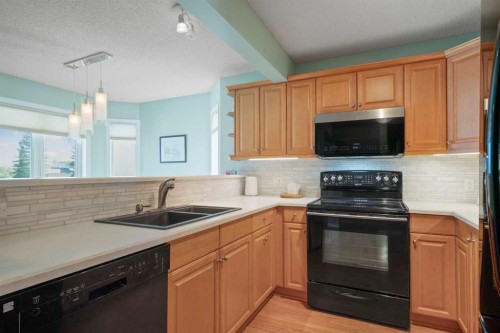 79 Scenic Gardens Nw, Calgary, AB - Indoor Photo Showing Kitchen With Double Sink