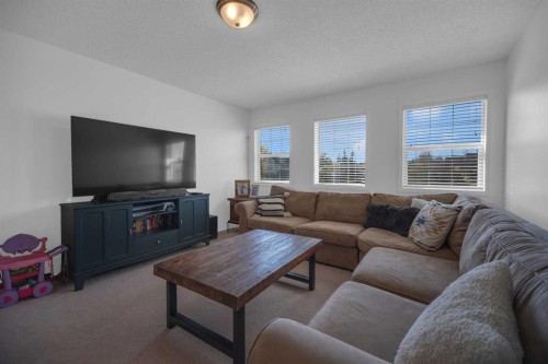 154 Bridlewood Court Sw, Calgary, AB - Indoor Photo Showing Living Room