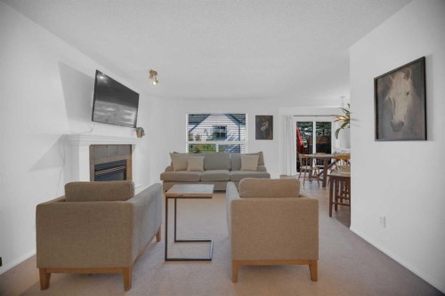 154 Bridlewood Court Sw, Calgary, AB - Indoor Photo Showing Living Room With Fireplace