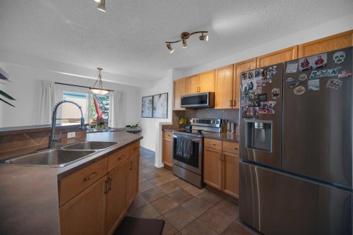 154 Bridlewood Court Sw, Calgary, AB - Indoor Photo Showing Kitchen With Stainless Steel Kitchen With Double Sink