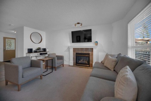 154 Bridlewood Court Sw, Calgary, AB - Indoor Photo Showing Living Room With Fireplace