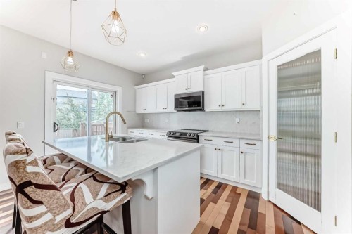 210 Copperleaf Bay Se, Calgary, AB - Indoor Photo Showing Kitchen With Double Sink