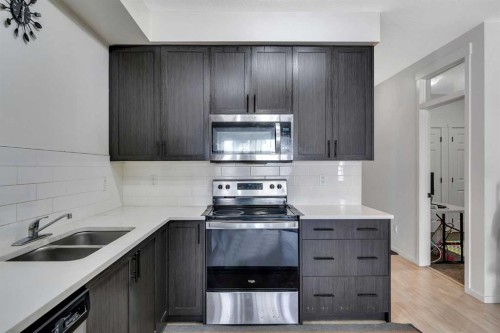 5114-151 Legacy Main Street Se, Calgary, AB - Indoor Photo Showing Kitchen With Stainless Steel Kitchen With Double Sink