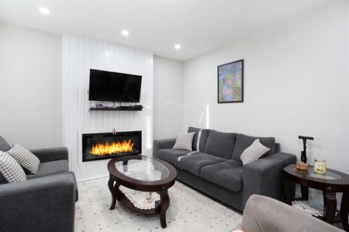 119 Maranda Close Ne, Calgary, AB - Indoor Photo Showing Living Room With Fireplace