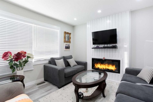 119 Maranda Close Ne, Calgary, AB - Indoor Photo Showing Living Room With Fireplace