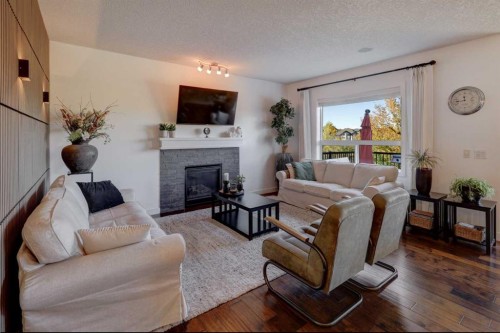 213 Kingsmere Cove Se, Airdrie, AB - Indoor Photo Showing Living Room With Fireplace