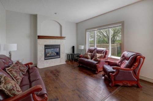 112 Cougarstone Manor Sw, Calgary, AB - Indoor Photo Showing Living Room With Fireplace