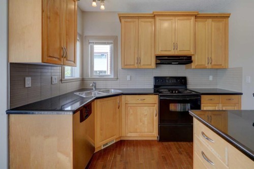 112 Cougarstone Manor Sw, Calgary, AB - Indoor Photo Showing Kitchen With Double Sink