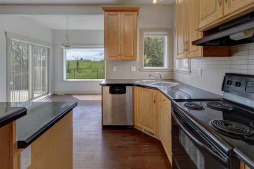 112 Cougarstone Manor Sw, Calgary, AB - Indoor Photo Showing Kitchen With Double Sink