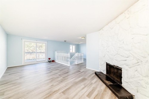 151 F Pinehill Road Ne, Calgary, AB - Indoor Photo Showing Living Room With Fireplace