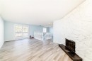 151 F Pinehill Road Ne, Calgary, AB  - Indoor Photo Showing Living Room With Fireplace 