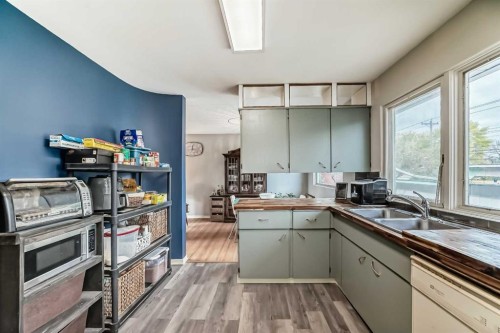 126 Springwood Drive Sw, Calgary, AB - Indoor Photo Showing Kitchen With Double Sink
