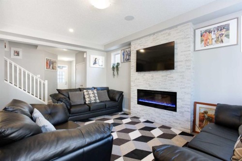 158 Osborne Common Sw, Airdrie, AB - Indoor Photo Showing Living Room With Fireplace
