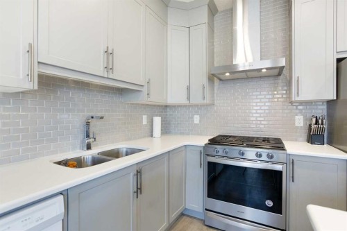 158 Osborne Common Sw, Airdrie, AB - Indoor Photo Showing Kitchen With Double Sink With Upgraded Kitchen