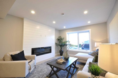 1 Cherovan Drive Sw, Calgary, AB - Indoor Photo Showing Living Room With Fireplace