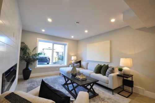 1 Cherovan Drive Sw, Calgary, AB - Indoor Photo Showing Living Room With Fireplace