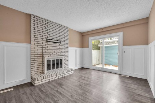 147 Scenic Way Nw, Calgary, AB - Indoor Photo Showing Living Room With Fireplace