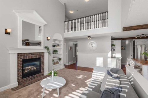 52 Canoe Road Sw, Airdrie, AB - Indoor Photo Showing Living Room With Fireplace