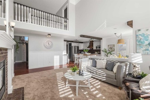52 Canoe Road Sw, Airdrie, AB - Indoor Photo Showing Living Room With Fireplace