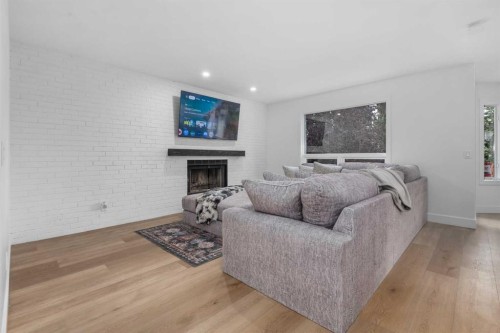 129 Sundown Place Se, Calgary, AB - Indoor Photo Showing Living Room With Fireplace