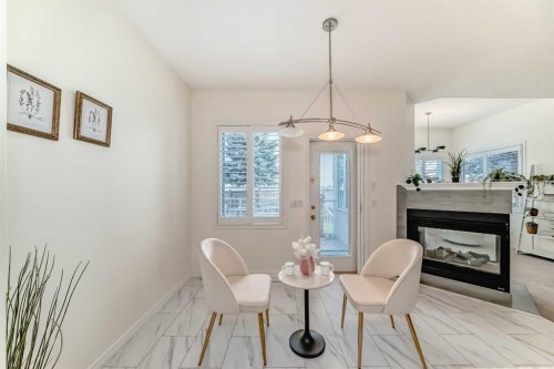82 Mt Gibraltar Heights Se, Calgary, AB - Indoor Photo Showing Dining Room With Fireplace