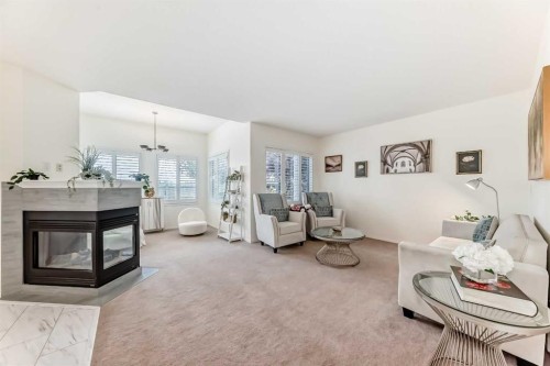 82 Mt Gibraltar Heights Se, Calgary, AB - Indoor Photo Showing Living Room With Fireplace