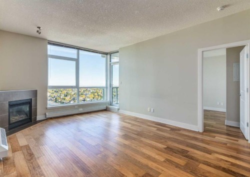 1801-77 Spruce Place Sw, Calgary, AB - Indoor Photo Showing Living Room With Fireplace