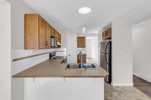 110 West Creek Bay, Chestermere, AB - Indoor Photo Showing Kitchen With Double Sink