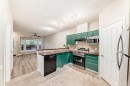 402-2066 Luxstone Boulevard Sw, Airdrie, AB  - Indoor Photo Showing Kitchen With Double Sink 