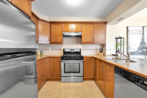 14 Windstone Lane Sw, Airdrie, AB - Indoor Photo Showing Kitchen With Double Sink