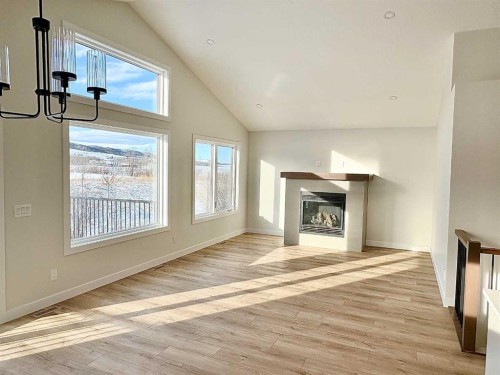 679 Anderson Close Nw, Diamond Valley, AB - Indoor With Fireplace
