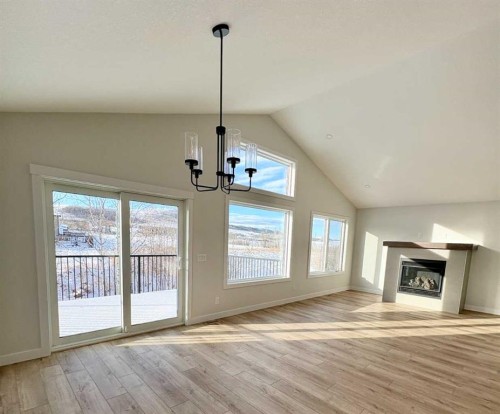 679 Anderson Close Nw, Diamond Valley, AB - Indoor With Fireplace