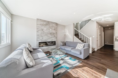 321 Carringvue Place Nw, Calgary, AB - Indoor Photo Showing Living Room With Fireplace