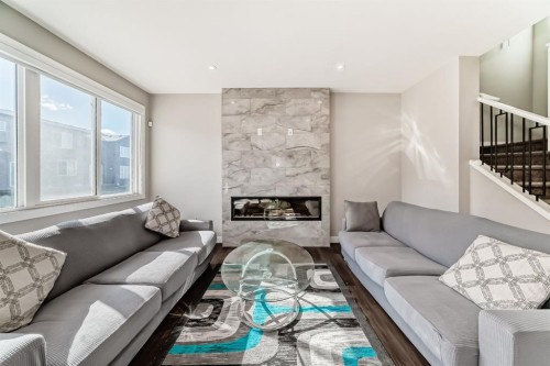 321 Carringvue Place Nw, Calgary, AB - Indoor Photo Showing Living Room With Fireplace