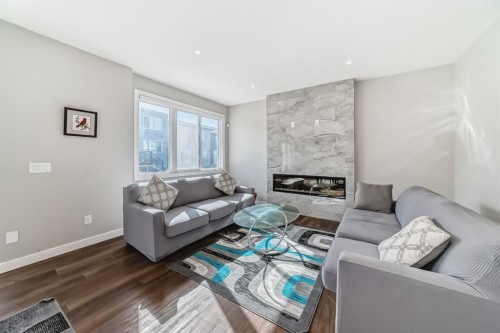 321 Carringvue Place Nw, Calgary, AB - Indoor Photo Showing Living Room With Fireplace