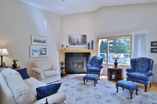 185 Hamptons Square Nw, Calgary, AB - Indoor Photo Showing Living Room With Fireplace
