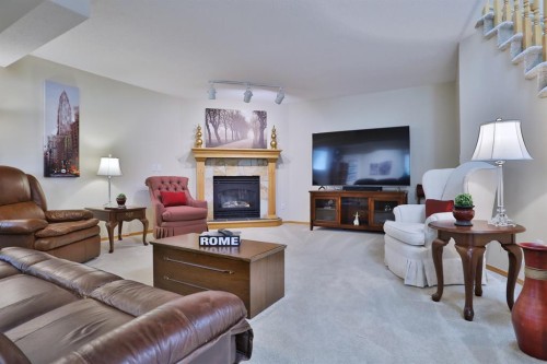 185 Hamptons Square Nw, Calgary, AB - Indoor Photo Showing Living Room With Fireplace