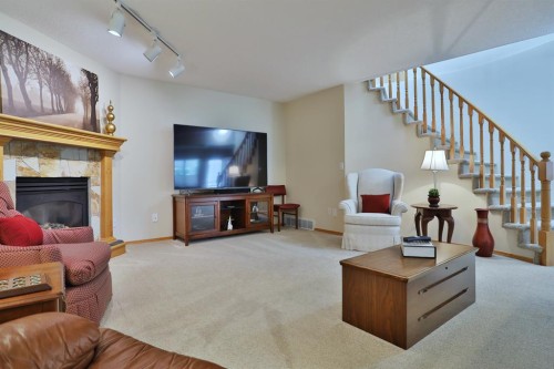 185 Hamptons Square Nw, Calgary, AB - Indoor Photo Showing Living Room With Fireplace
