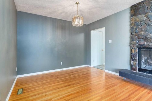 244 Maple Court Crescent Se, Calgary, AB - Indoor Photo Showing Other Room With Fireplace