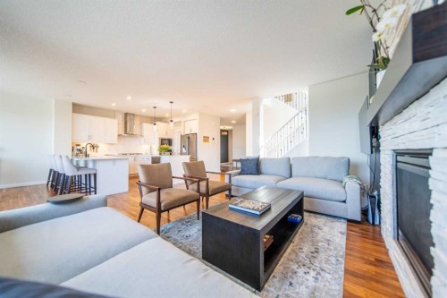 27 Sunset Park, Cochrane, AB - Indoor Photo Showing Living Room With Fireplace