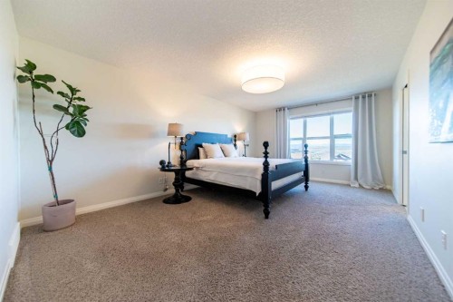 27 Sunset Park, Cochrane, AB - Indoor Photo Showing Bedroom