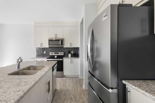 124 Carringham Way Nw, Calgary, AB - Indoor Photo Showing Kitchen With Stainless Steel Kitchen With Double Sink With Upgraded Kitchen