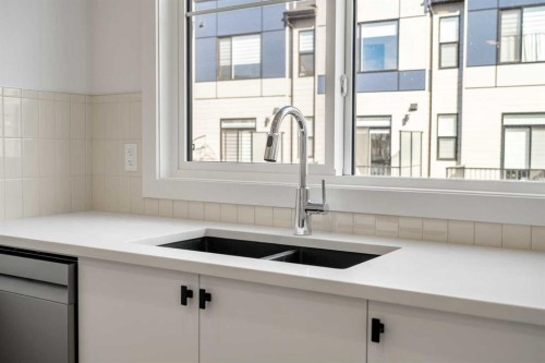 302-550 Seton Circle Se, Calgary, AB - Indoor Photo Showing Kitchen With Double Sink