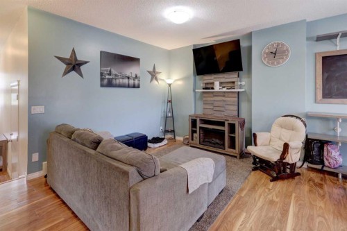 468 Hillcrest Circle Sw, Airdrie, AB - Indoor Photo Showing Living Room With Fireplace