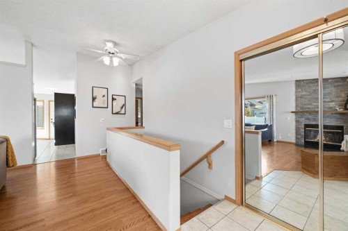 177 Hidden Vale Close Nw, Calgary, AB - Indoor Photo Showing Other Room With Fireplace