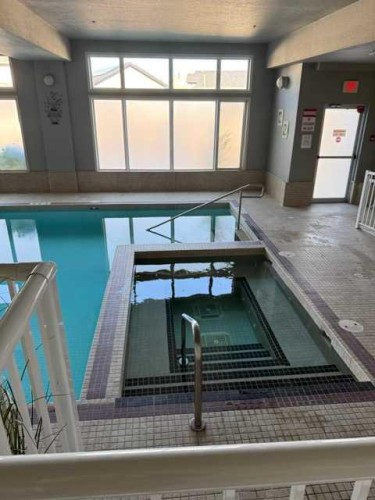 203-15 Everstone Drive Sw, Calgary, AB - Indoor Photo Showing Other Room With In Ground Pool